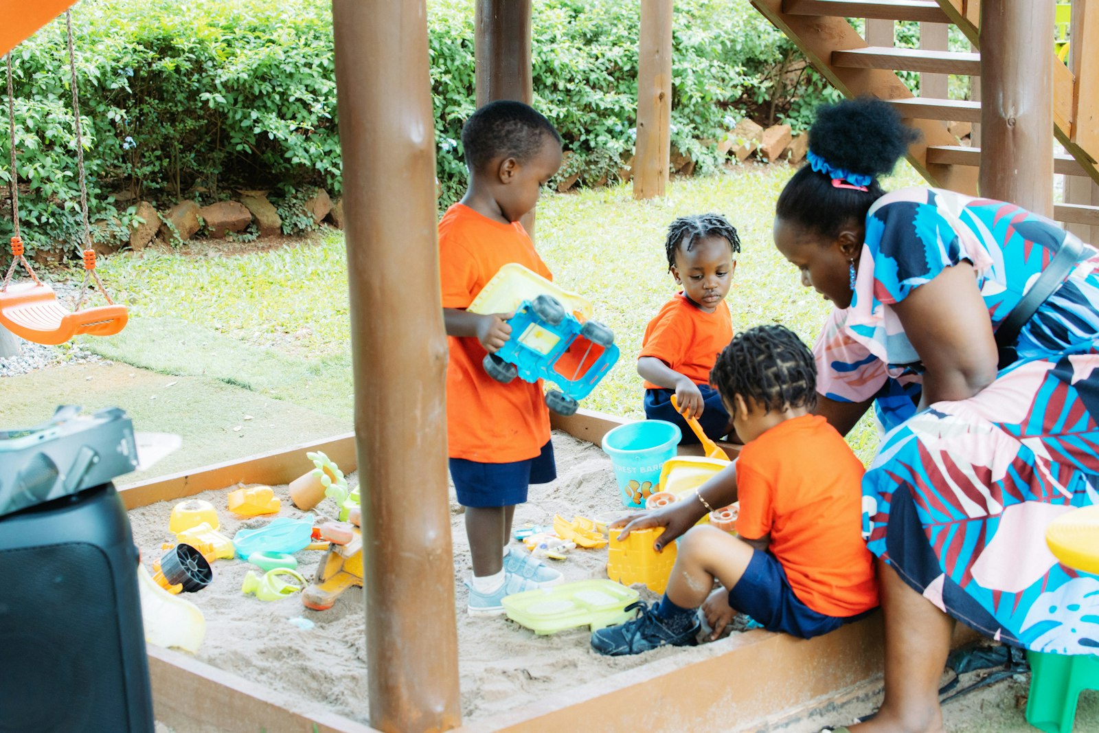 Aboriginal preschool children playing together outdoors with an educator
