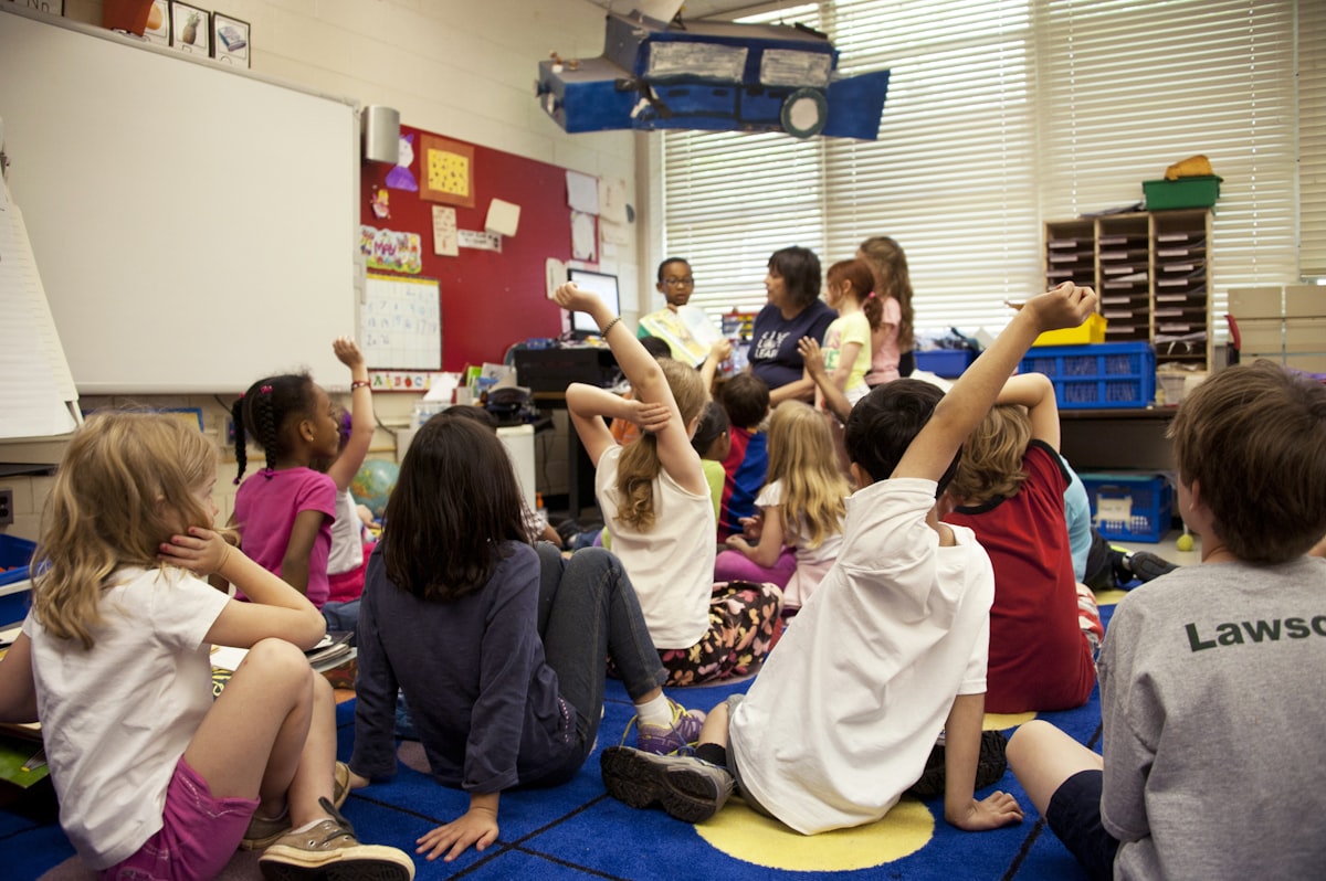 Educator reading with a group of young children sitting in a circle