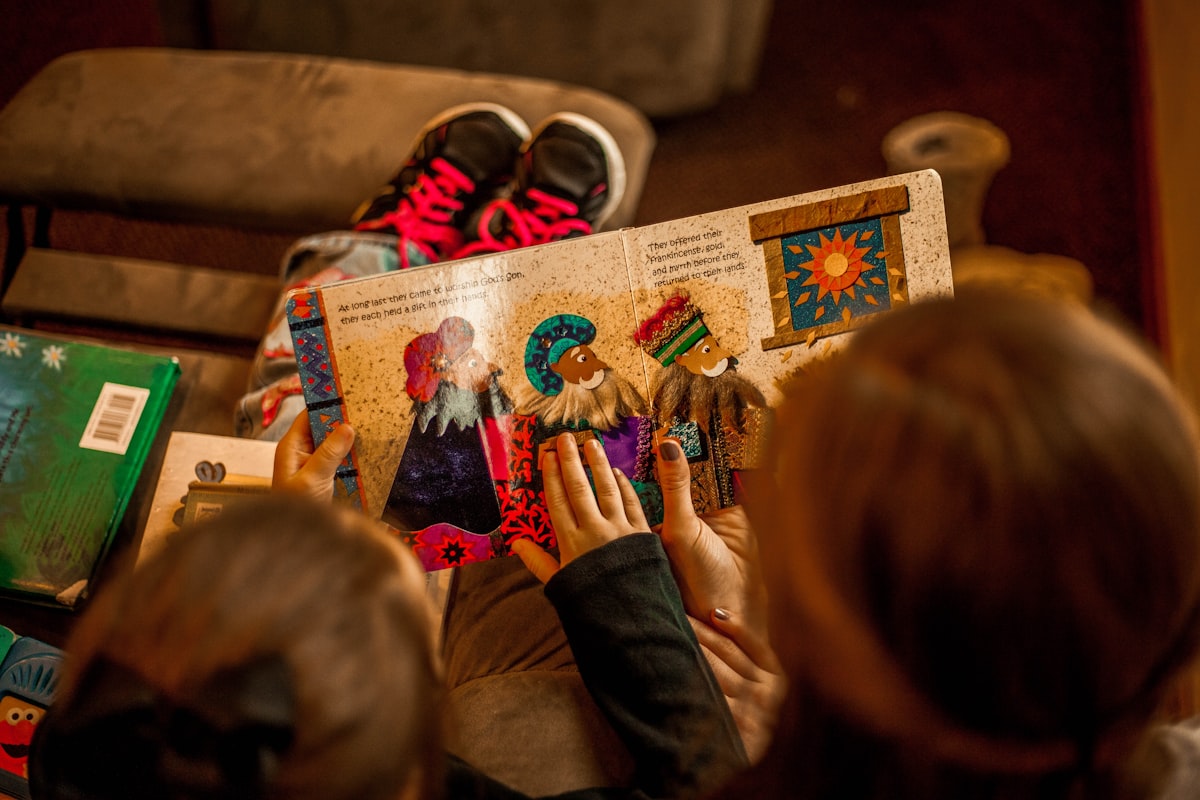 Children reading a book together