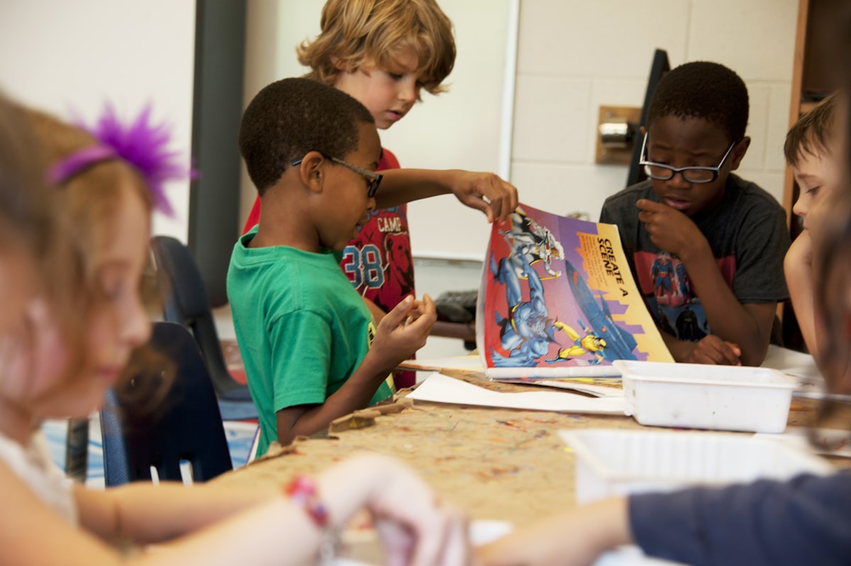 Young children reading picture books together